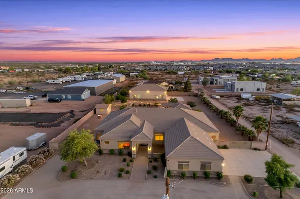 a backyard of a house with table and chairs