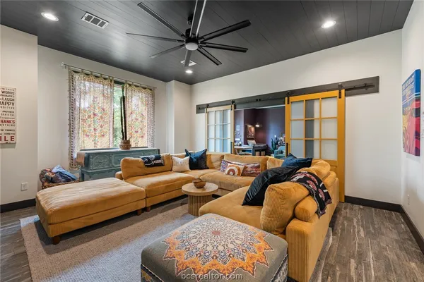 a living room with furniture and a wooden floor