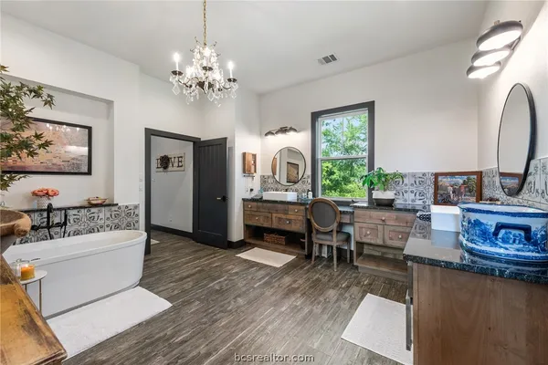 a bedroom with furniture and a wooden floor
