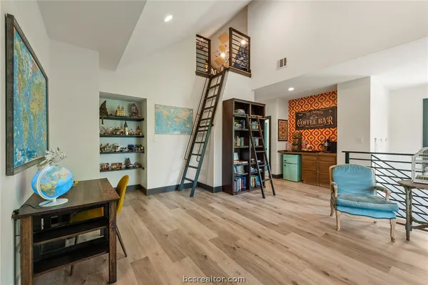 a view of a room with gym equipment and a window