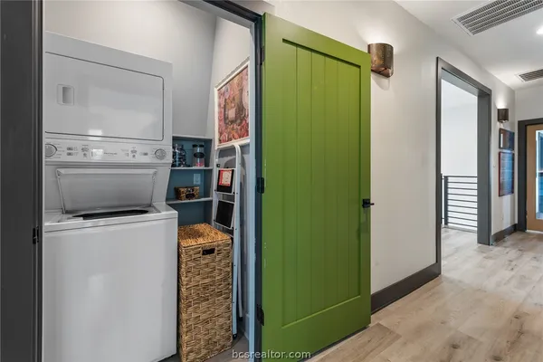 a bedroom with furniture and a large window