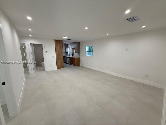 328 Northeast 57th Street Miami, FL 33137 - Photo 2 of 15 an empty room with a refrigerator and car parked