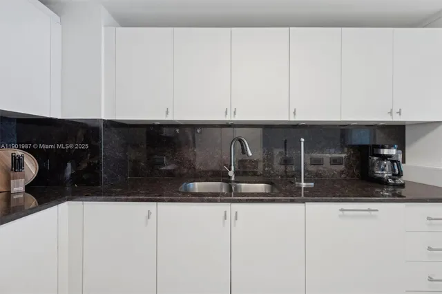a kitchen with a stove microwave and sink