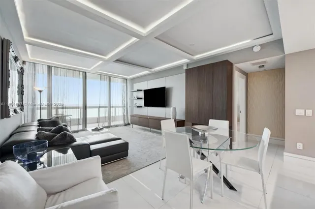 a view of a dining room with furniture and a chandelier