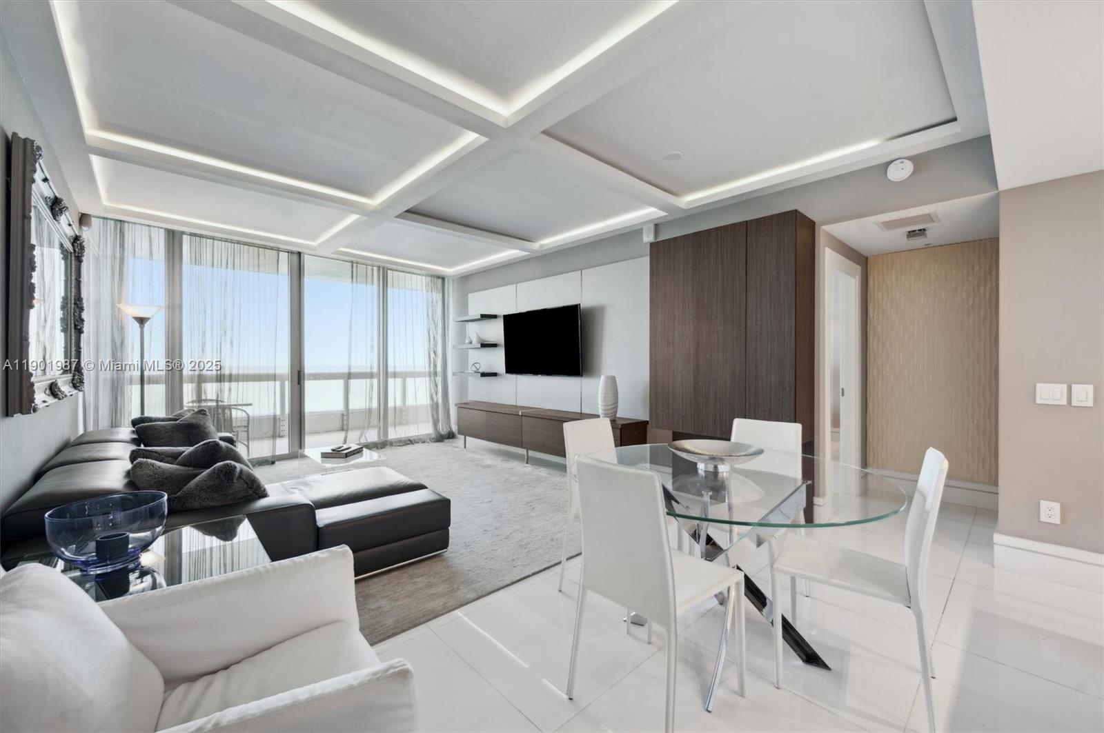 6899 Collins Avenue, Unit 702 Miami Beach, FL 33141 - Photo 15 of 47 a living room with furniture and a flat screen tv