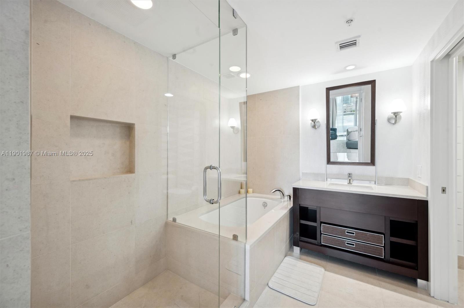 6899 Collins Avenue, Unit 702 Miami Beach, FL 33141 - Photo 20 of 47 a bathroom with a double vanity sink a mirror and a shower