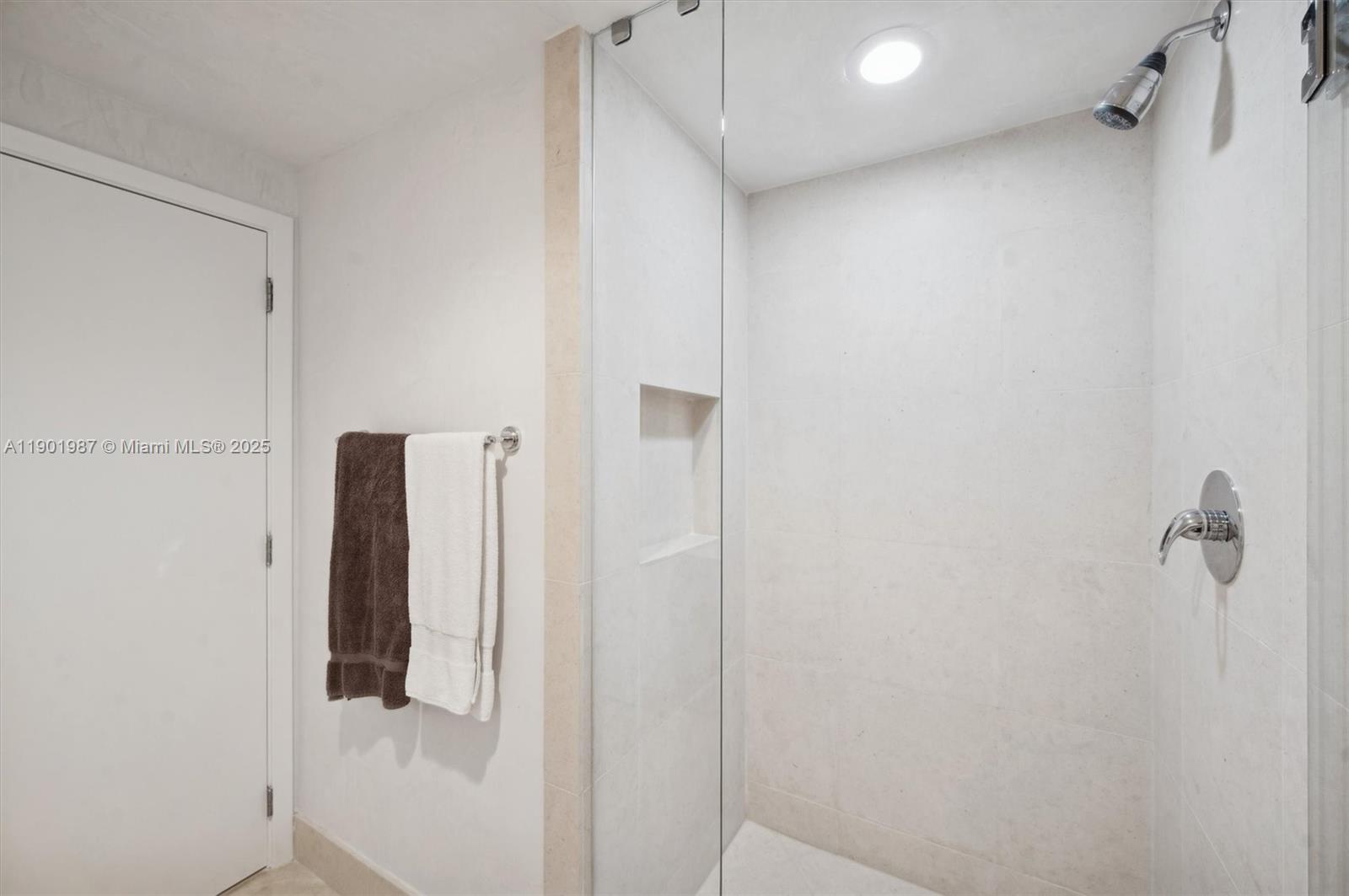 6899 Collins Avenue, Unit 702 Miami Beach, FL 33141 - Photo 24 of 47 a bathroom with a shower and a glass door
