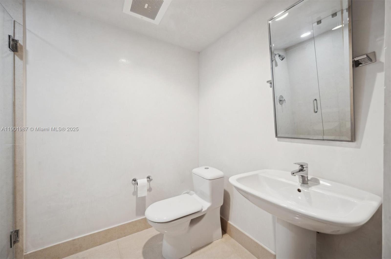 6899 Collins Avenue, Unit 702 Miami Beach, FL 33141 - Photo 25 of 47 a bathroom with a sink toilet and a mirror