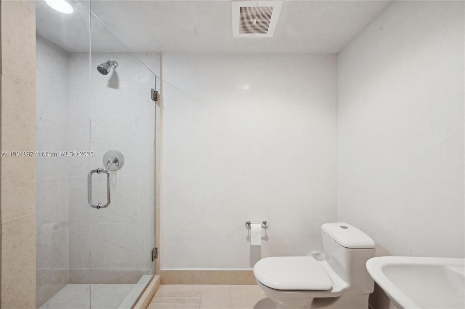 6899 Collins Avenue, Unit 702 Miami Beach, FL 33141 - Photo 26 of 47 a bathroom with a toilet a sink and shower
