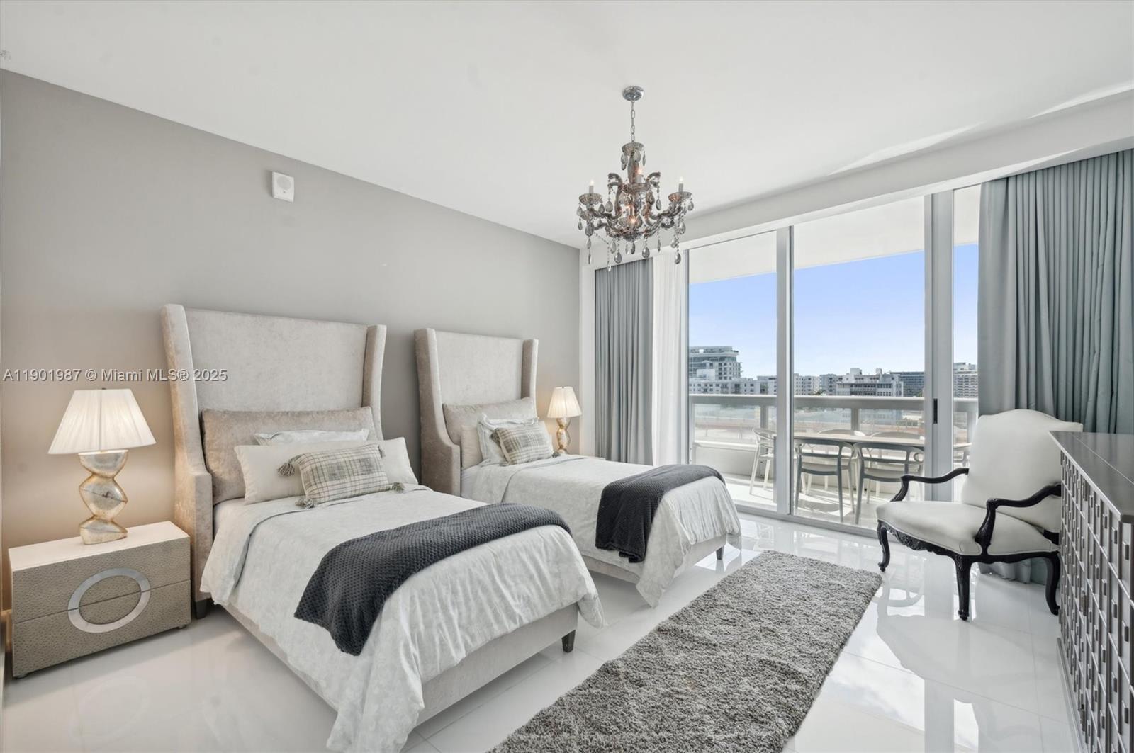 6899 Collins Avenue, Unit 702 Miami Beach, FL 33141 - Photo 29 of 47 a bedroom with double bed and large windows