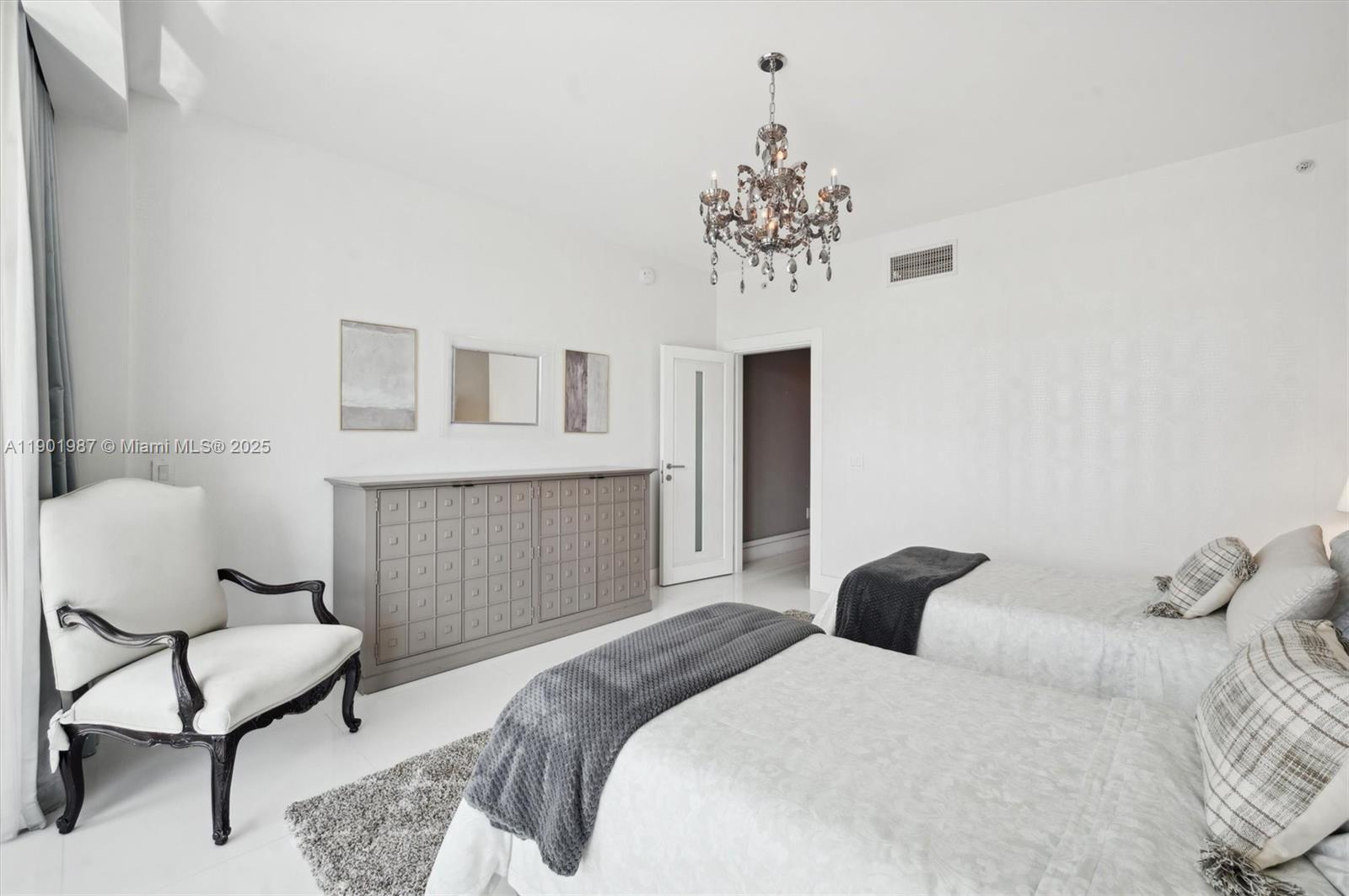 6899 Collins Avenue, Unit 702 Miami Beach, FL 33141 - Photo 30 of 47 a bedroom with a bed and a chair
