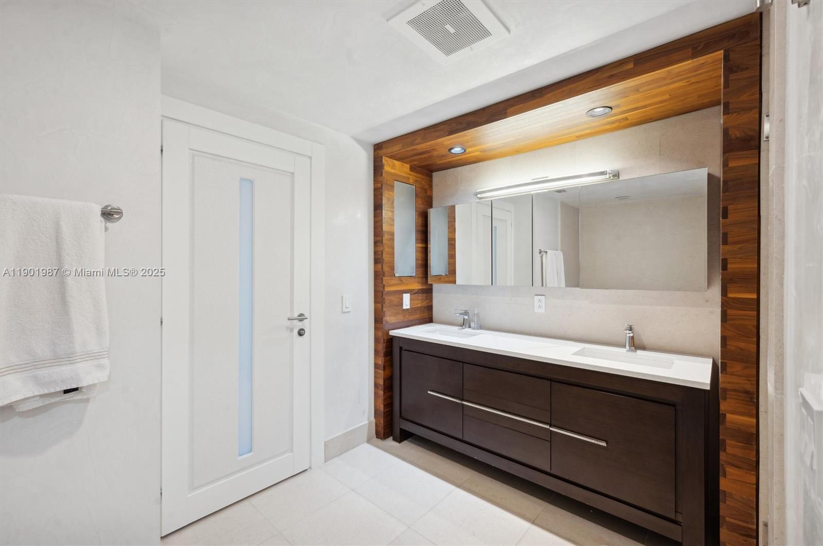 6899 Collins Avenue, Unit 702 Miami Beach, FL 33141 - Photo 31 of 47 a bathroom with a double vanity sink and mirror