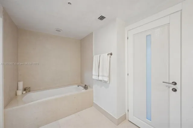a spacious bathroom with a bathtub and toilet
