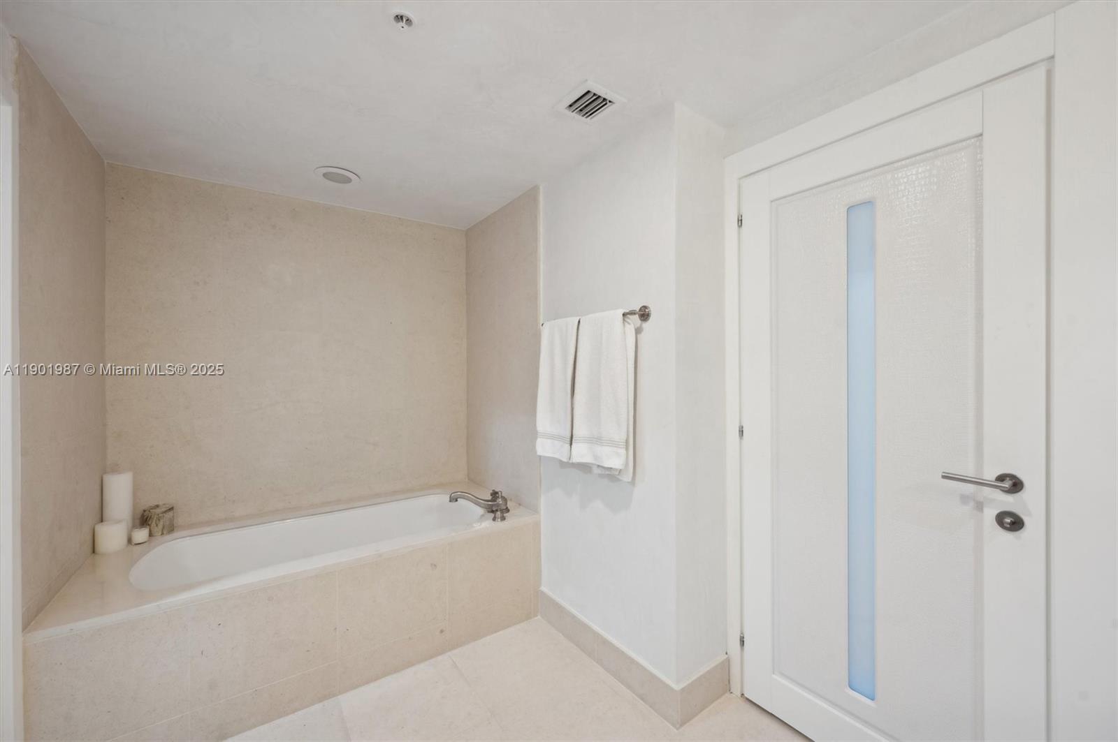 6899 Collins Avenue, Unit 702 Miami Beach, FL 33141 - Photo 32 of 47 a white bath tub sitting next to a white cabinet