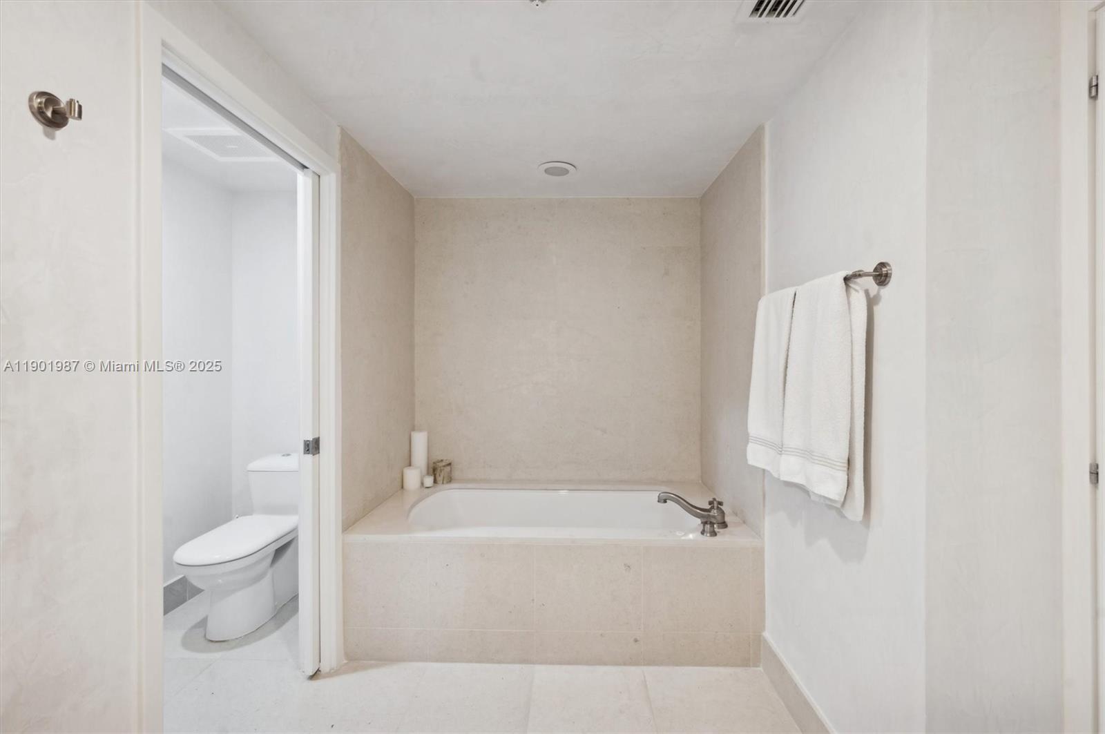 6899 Collins Avenue, Unit 702 Miami Beach, FL 33141 - Photo 33 of 47 a spacious bathroom with a bathtub and toilet