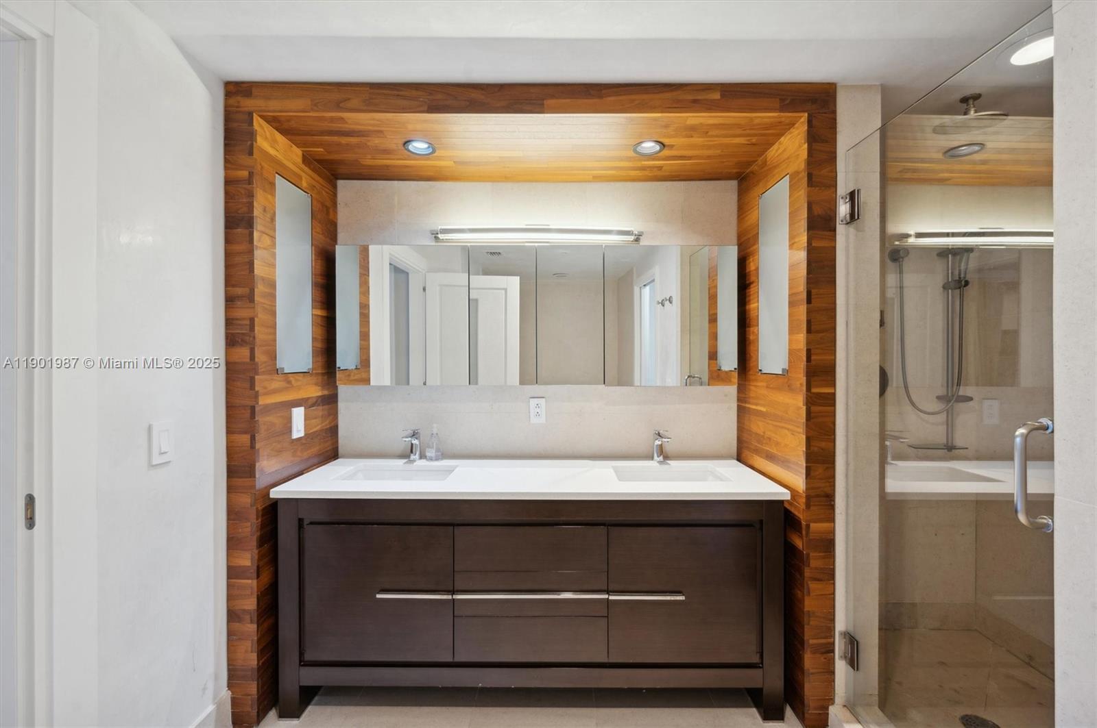 6899 Collins Avenue, Unit 702 Miami Beach, FL 33141 - Photo 34 of 47 a bathroom with a sink a mirror and a shower