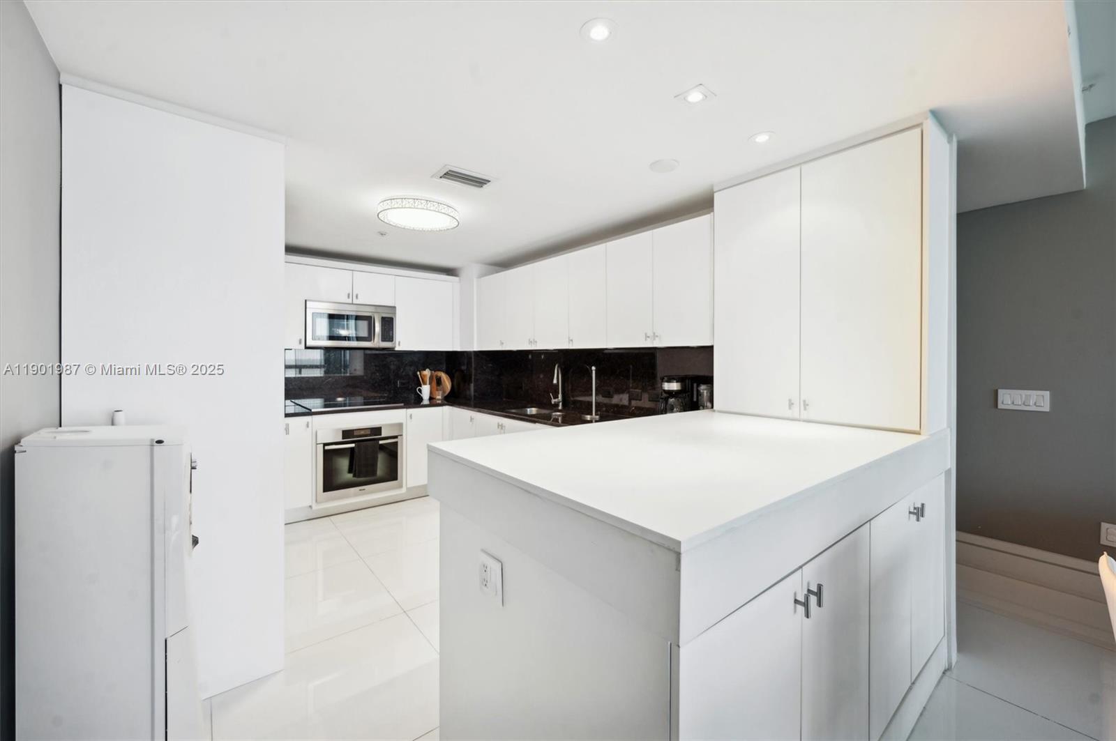 6899 Collins Avenue, Unit 702 Miami Beach, FL 33141 - Photo 9 of 47 a view of kitchen with stainless steel appliances a refrigerator and a stove