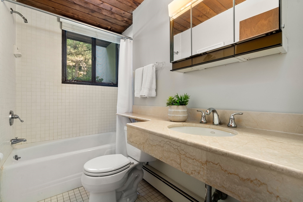 35 Sedgemeadow Road Wayland, MA 01778 - Photo 28 of 29 a bathroom with a granite countertop sink mirror vanity and toilet