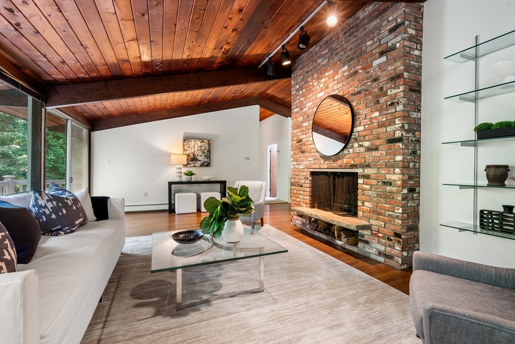 35 Sedgemeadow Road Wayland, MA 01778 - Photo 8 of 29 a living room with furniture a fireplace and a flat screen tv