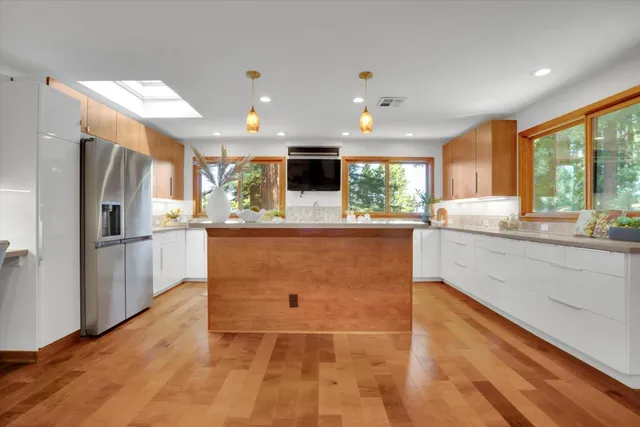 a kitchen with a sink and a large window