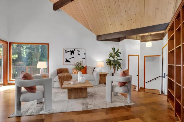 a bedroom with a large bed and wooden floor