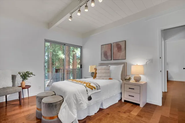 a kitchen with stainless steel appliances granite countertop a stove top oven a sink dishwasher a dining table and chairs with wooden floor