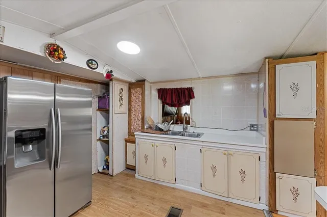 a kitchen with stainless steel appliances a refrigerator and a sink