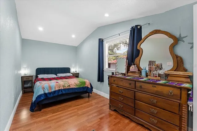 a bedroom with a bed and with furniture