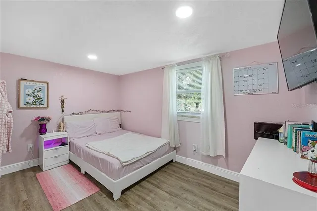 a bedroom with a bed and a table in it