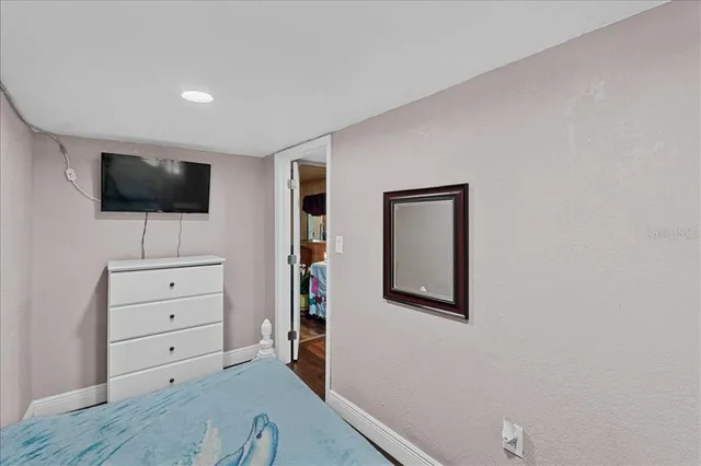 a living room with cabinets and a flat screen tv