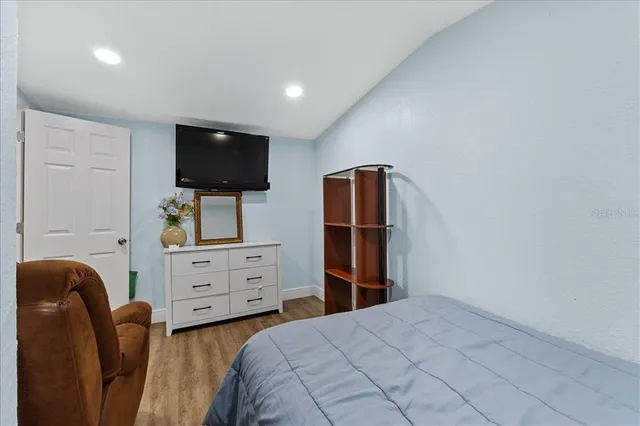 a bedroom with a bed and a flat screen tv
