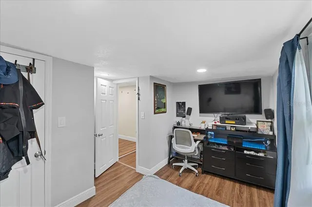 a view of a workspace with furniture and a window