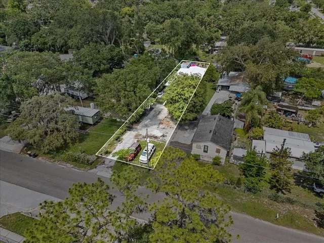 an aerial view of a house with a yard and lake view