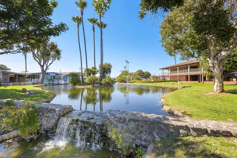 a view of a lake with a building and trees all around