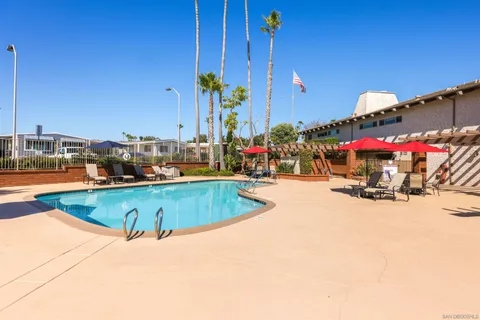 a view of a swimming pool with outdoor seating