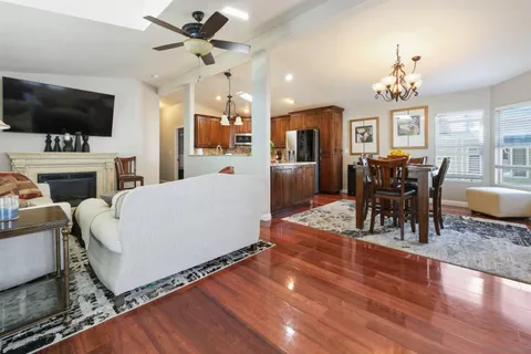 a living room with furniture fireplace and flat screen tv