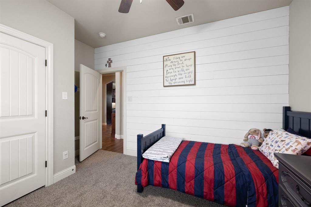 2103 Cash Point Court Granbury, TX 76049 - Photo 24 of 38 a bedroom with a bed and dresser