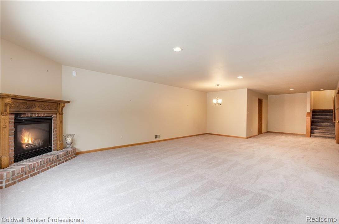 3388 Rivers Edge Drive, Unit 2 Wayne, MI 48184 - Photo 18 of 42 Brick surround gas fireplace, new neutral carpeting, recessed lighting.
