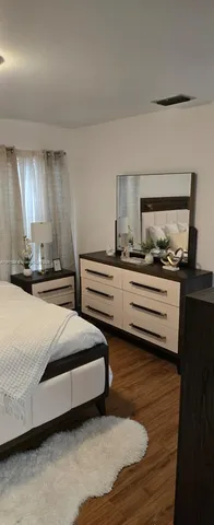 a bedroom with bed and window