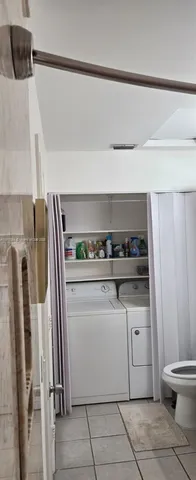 a white refrigerator freezer and a stove sitting inside of a kitchen