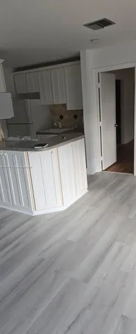 a view of a utility room with wooden floor