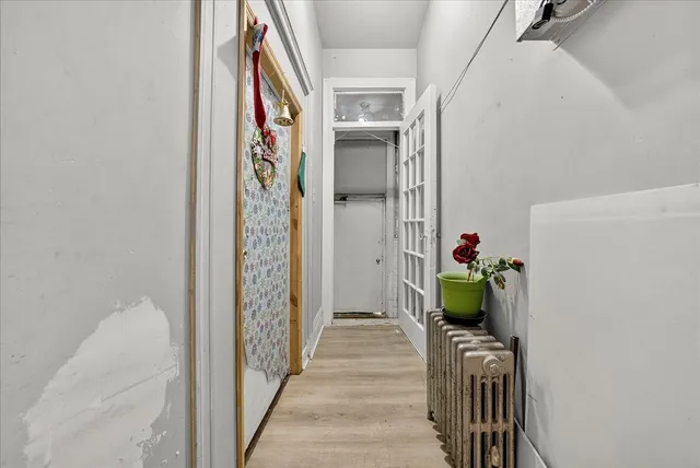 a view of an entryway with wooden floor