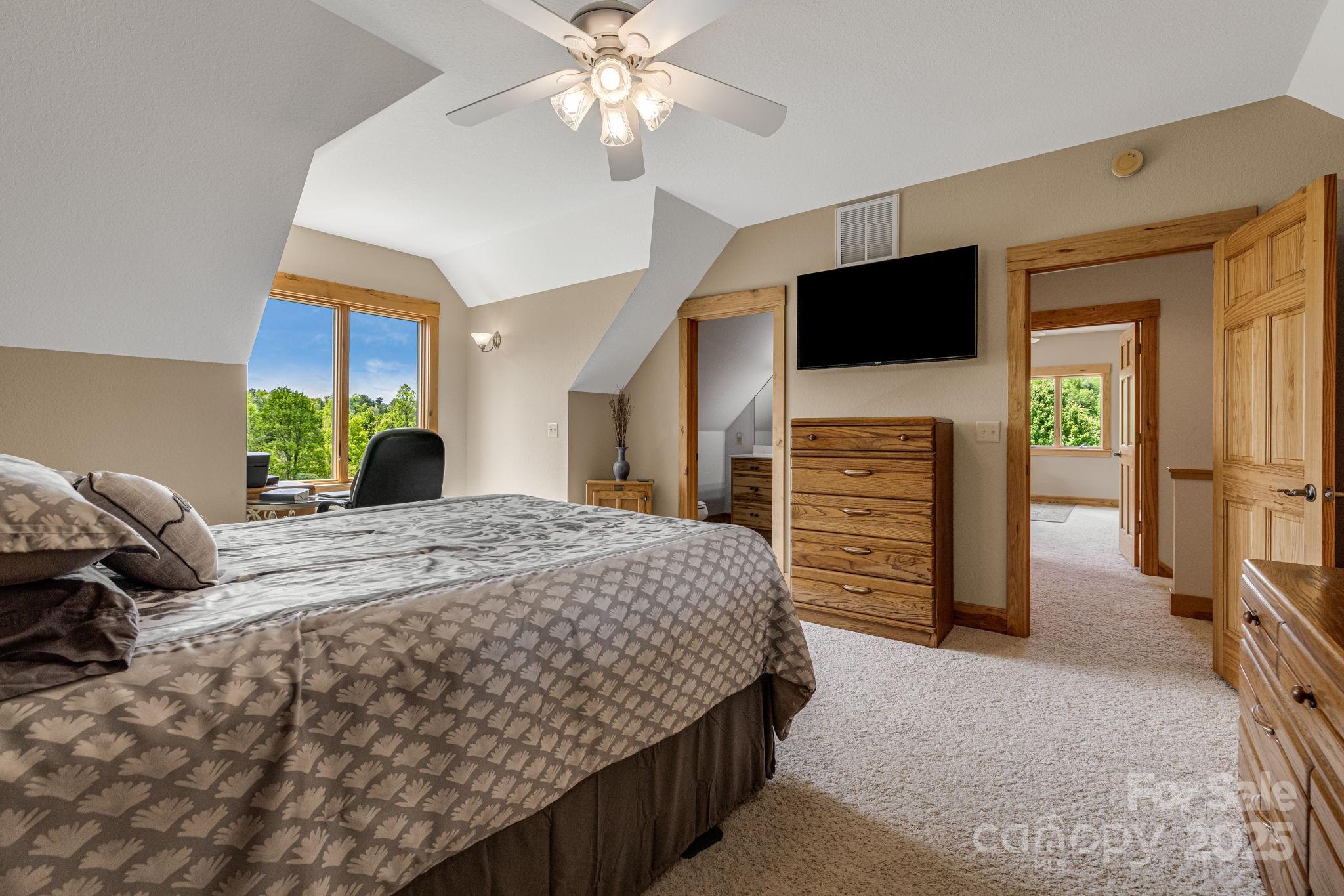 2912 Windswept Ridge Road Marshall, NC 28753 - Photo 24 of 47 a bedroom with a bed and a flat screen tv