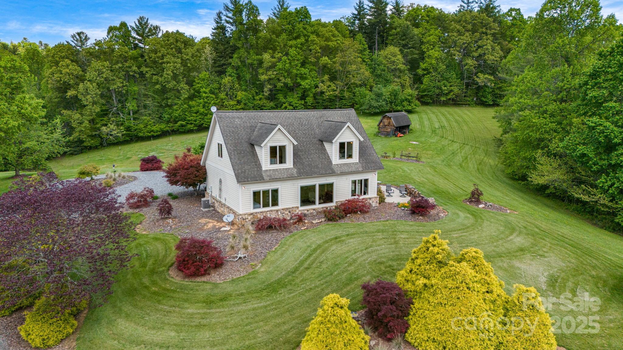 2912 Windswept Ridge Road Marshall, NC 28753 - Photo 46 of 47 a aerial view of a house with a yard table and chairs