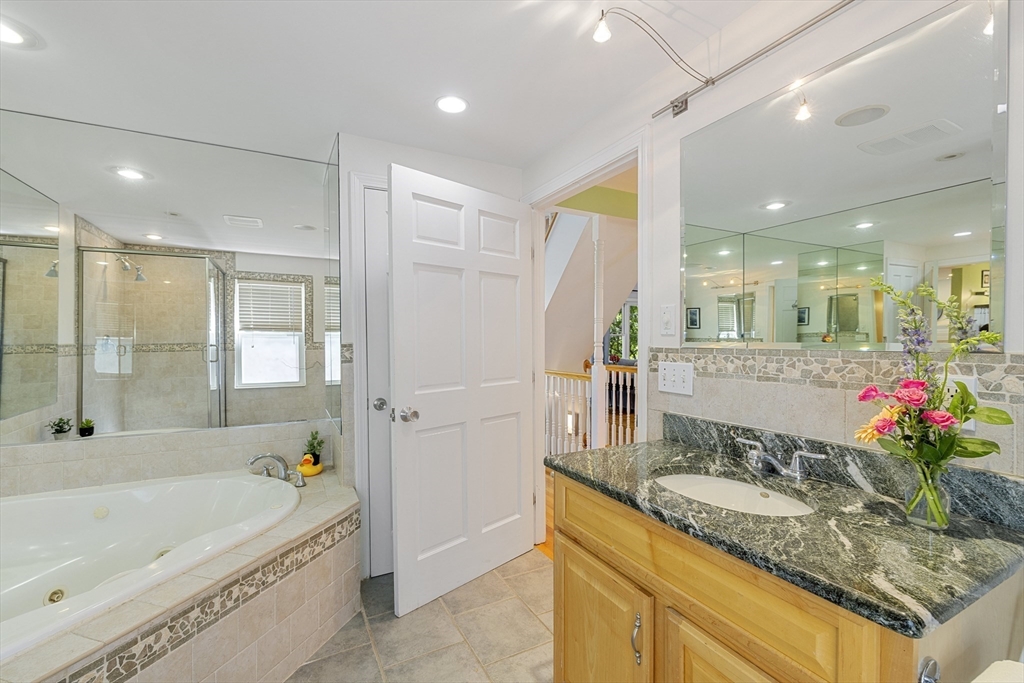 8 Hatch Road Medford, MA 02155 - Photo 19 of 42 a bathroom with a granite countertop sink mirror bathtub and shower