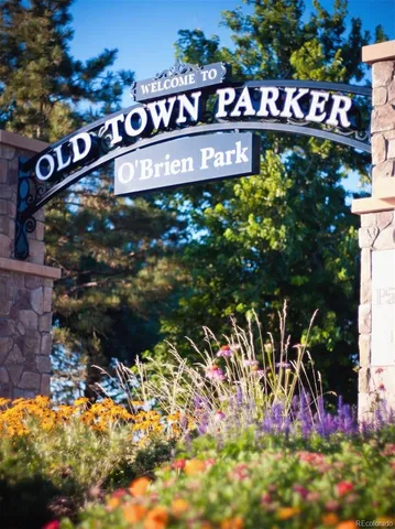 a street sign that is sitting in front of flowers