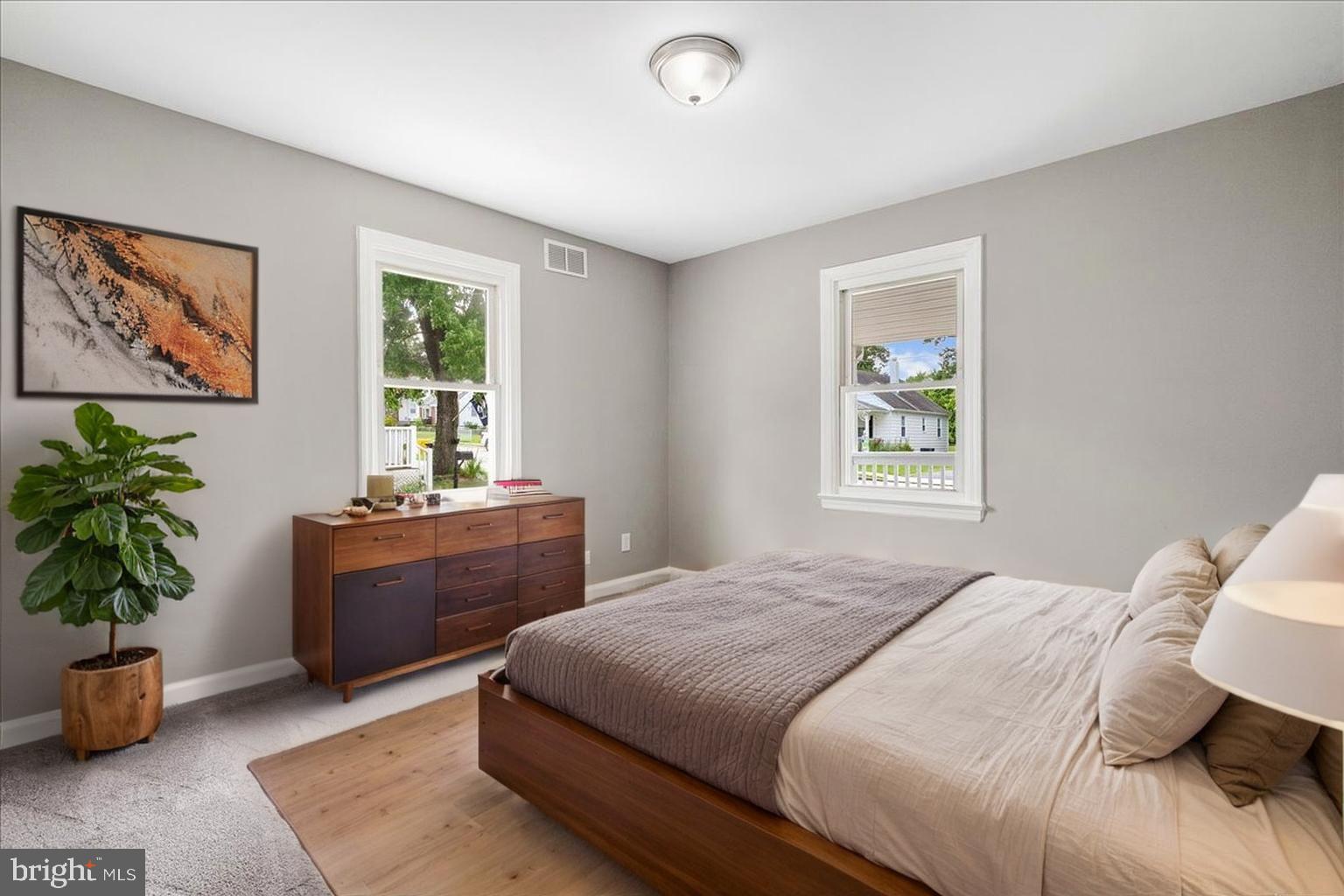 25 Mansion Road Linthicum Heights, MD 21090 - Photo 13 of 26 a bedroom with a large bed and a potted plant