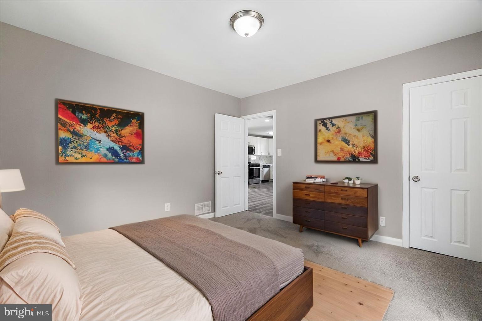 25 Mansion Road Linthicum Heights, MD 21090 - Photo 14 of 26 a bedroom with bed and paintings on the wall