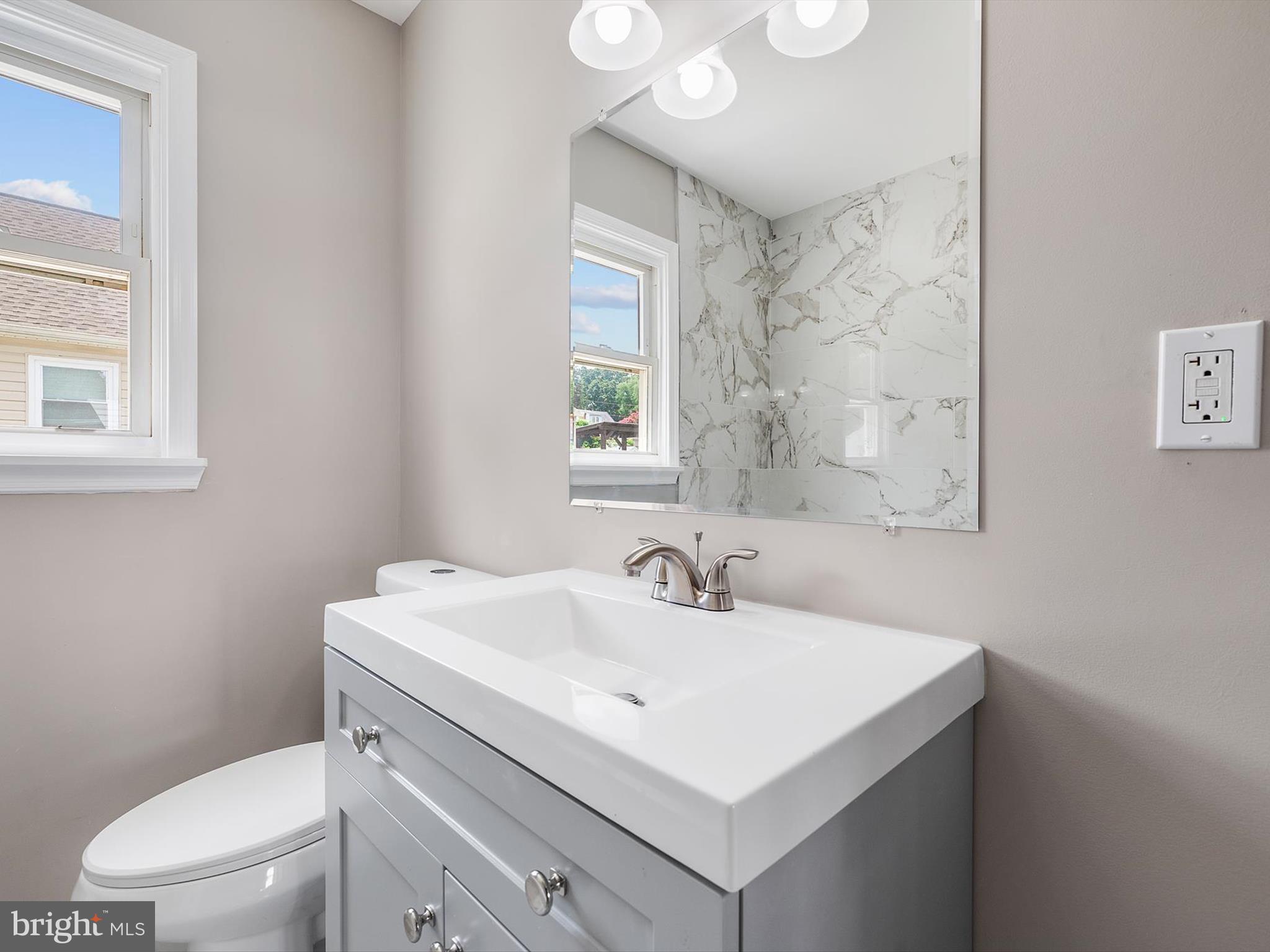 25 Mansion Road Linthicum Heights, MD 21090 - Photo 15 of 26 a bathroom with a sink a toilet and a window