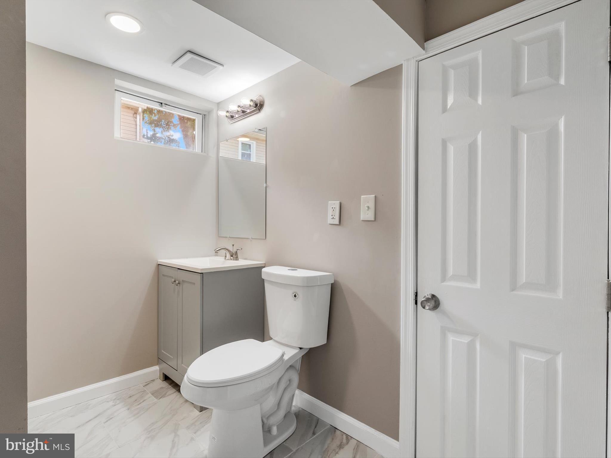 25 Mansion Road Linthicum Heights, MD 21090 - Photo 22 of 26 a white toilet sitting next to a bathroom sink